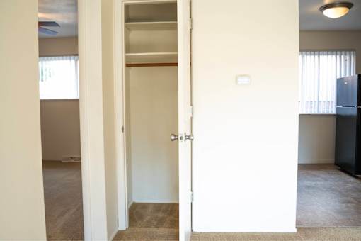 A white door with a silver handle is open.