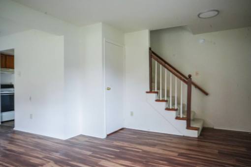 A room with a staircase and a door.
