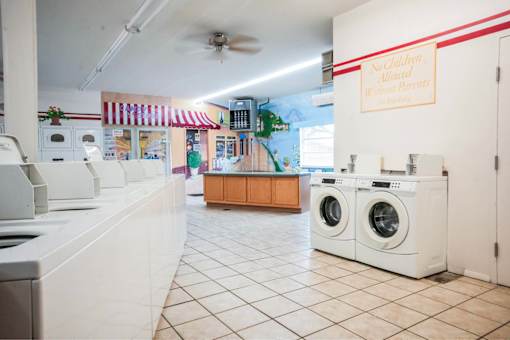 A laundromat with a sign that says "No Children Allowed".