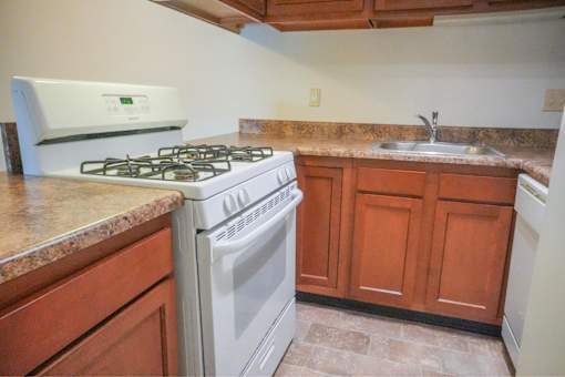 A kitchen with stove and sink.