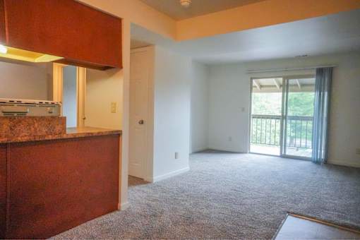 A room with a brown counter and carpeted floor.