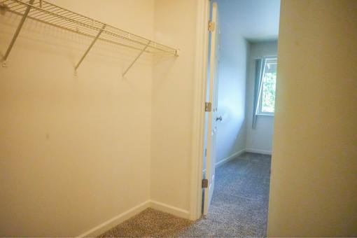 A white wall with a metal rack on it.
