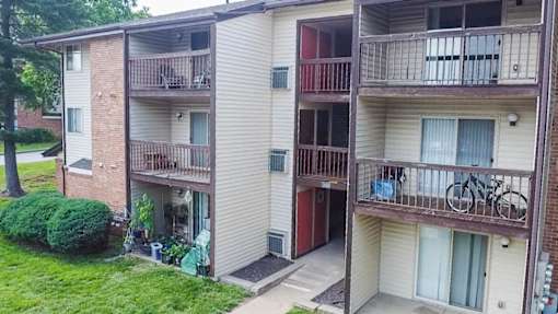 Apartment building with a bicycle on the balcony.