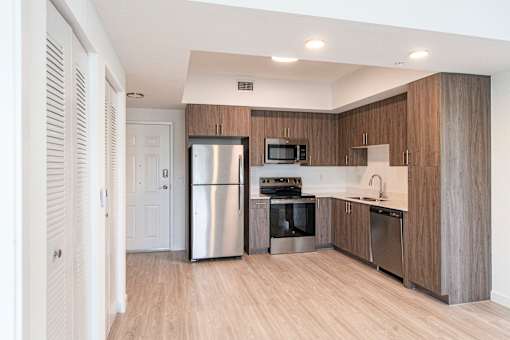 A modern kitchen with wooden cabinets and stainless steel appliances.