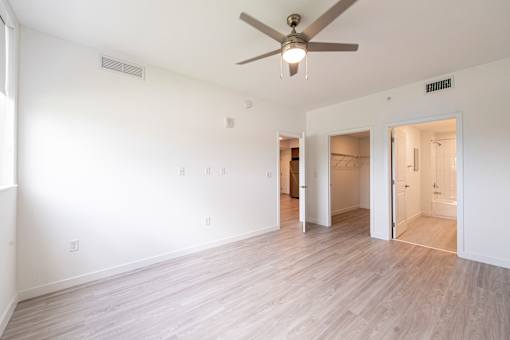 A room with a ceiling fan and light fixture.