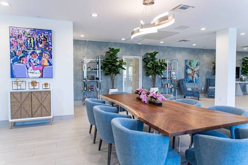 A conference room with a long table and chairs.
