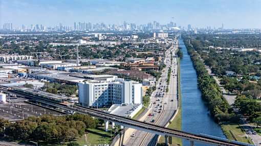 A river runs through a city with a bridge over it.