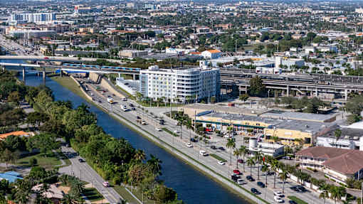 A river runs through a city with a bridge over it.