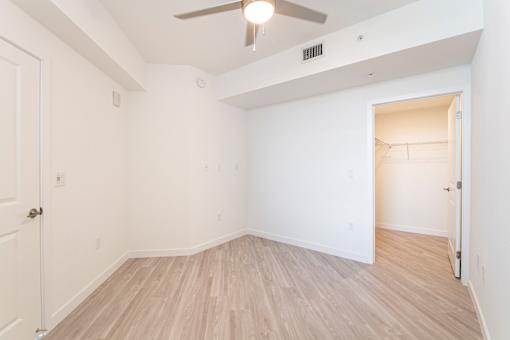 A room with a ceiling fan and light fixture.