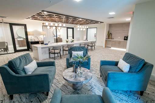 A modern living room with grey couches and a wooden ceiling.