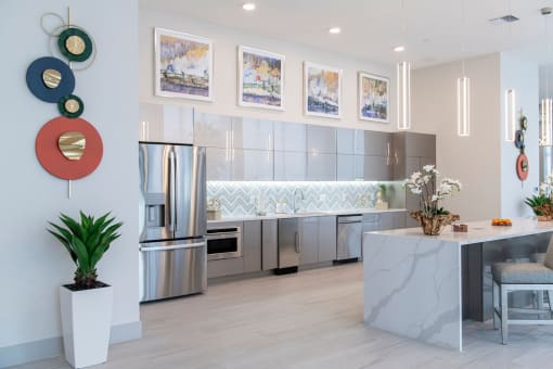 a kitchen with stainless steel appliances and a marble counter top