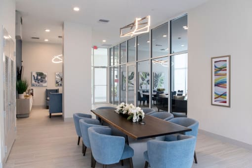 a dining room with blue chairs and a table