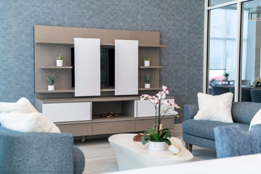 a living room with blue furniture and a white coffee table