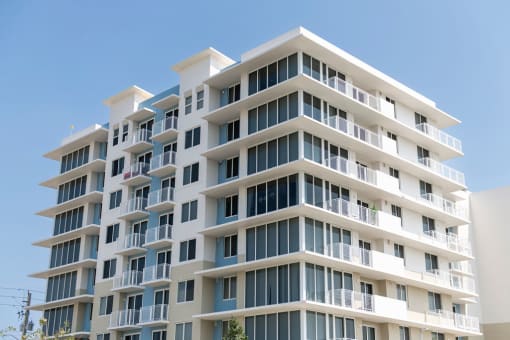 a building with many balconies and a blue sky
