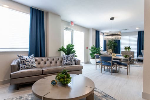 a living room and dining room with a table and couch
