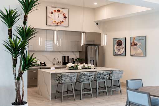 A modern kitchen with a dining table set for six.