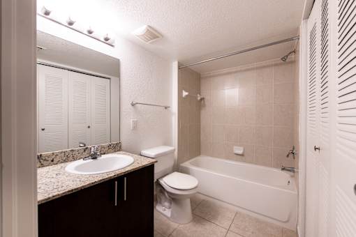 A bathroom with a sink, toilet, and bathtub.