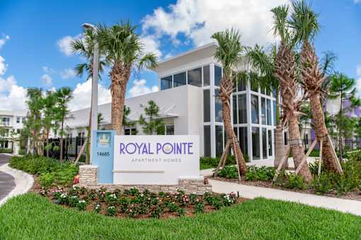 A sign that says Royal Pointe in front of a building.