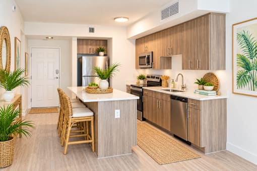 A kitchen with a table and chairs and a fridge.