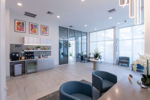 a living room with a kitchen and a table and chairs