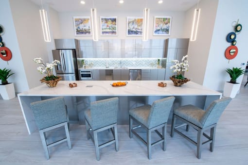 a kitchen with a large island and chairs
