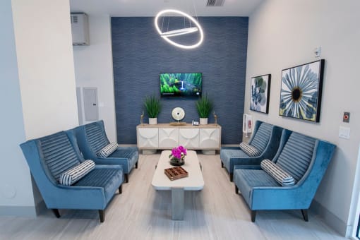 a living room with blue couches and a tv