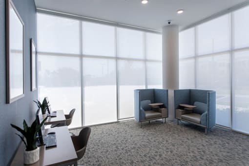 a room with windows and chairs and a table
