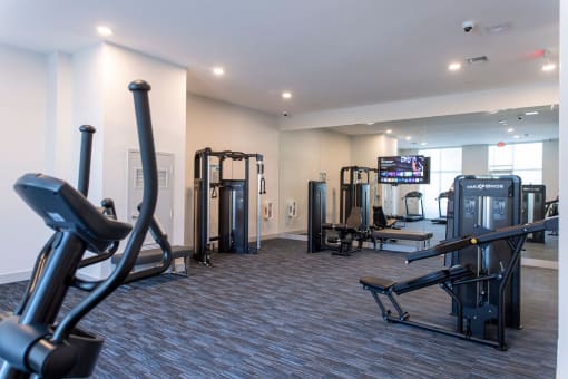 a gym with weights and other exercise equipment in a building
