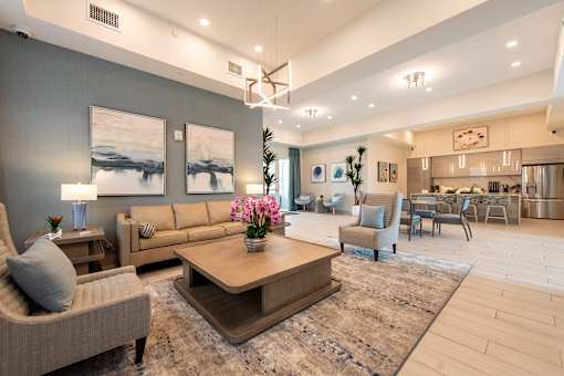 A modern living room with a large coffee table and comfortable seating.