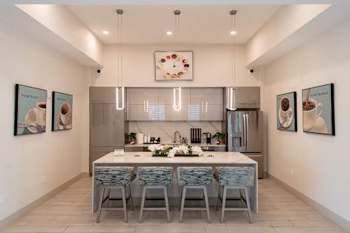A modern kitchen with a dining table and chairs.