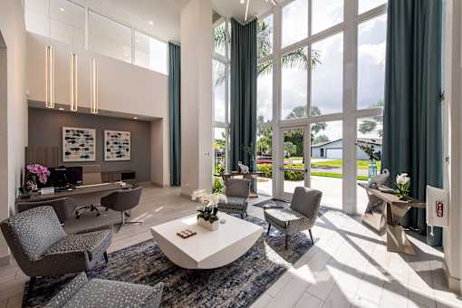 A modern living room with a large window and a white coffee table.