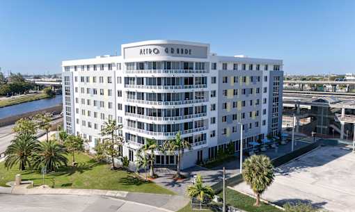 A white hotel with the name Arbo on the top.