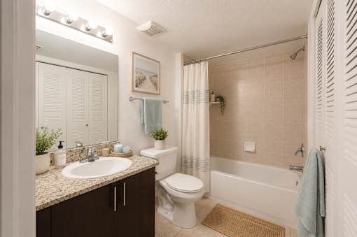 A bathroom with a toilet, sink, and bathtub.