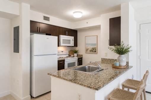 A kitchen with granite countertops and stainless steel appliances.