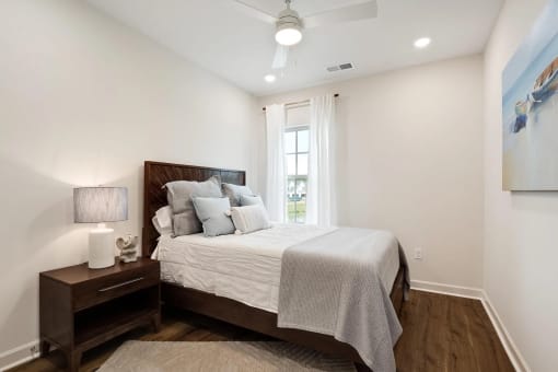 a bedroom with a bed and a window