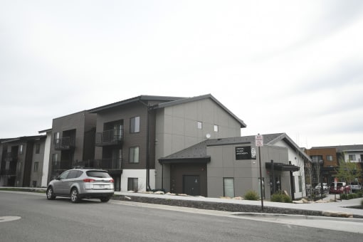 a silver car parked in front of a building