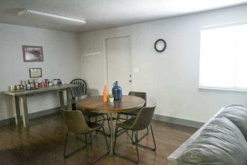 a living room with a table and chairs and a couch