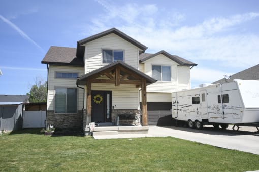 a house with an rv parked in front of it
