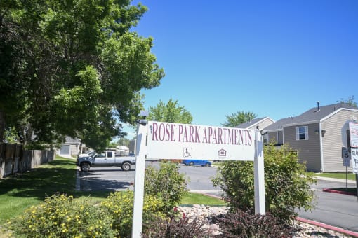 a sign for front park apartments in front of a parking lot