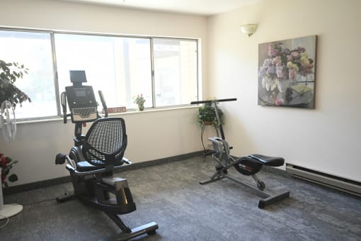 a workout room with an exercise bike and a window
