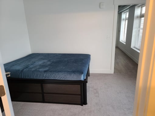 a bedroom with a bed and a window