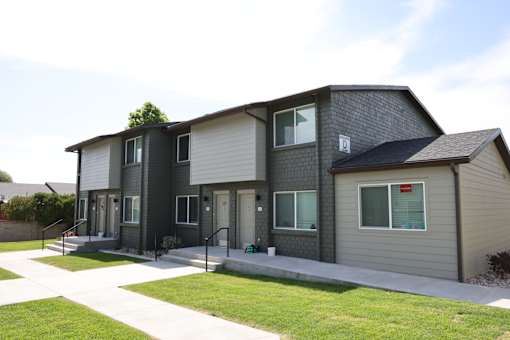 A modern two-story house with a grey and white exterior.