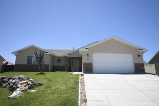 a house with a white garage door and a lawn