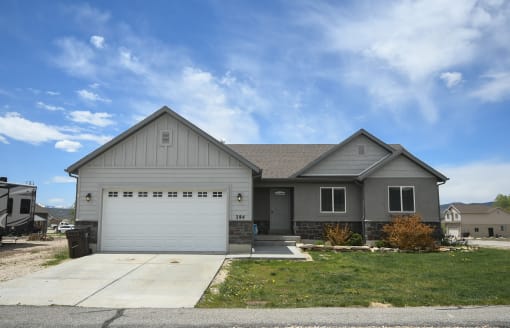 a gray house with a white garage door