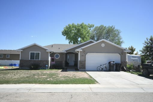 a tan house with a white garage door