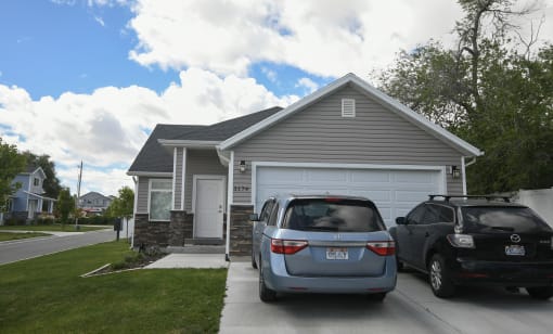 a house with two cars parked in front of it