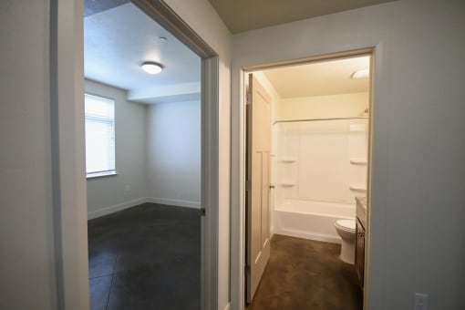 a view of a bathroom from a hallway with a door to a toilet and a