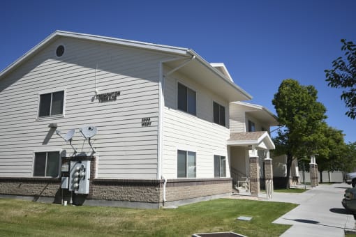 a white house with a basketball hoop on the side of it