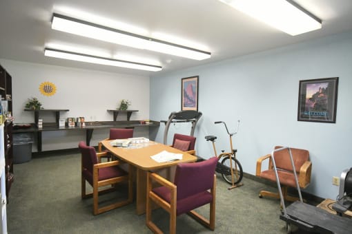 a conference room with a table and chairs and a bike in the corner