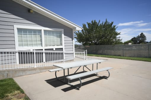 a picnic table in front of a house